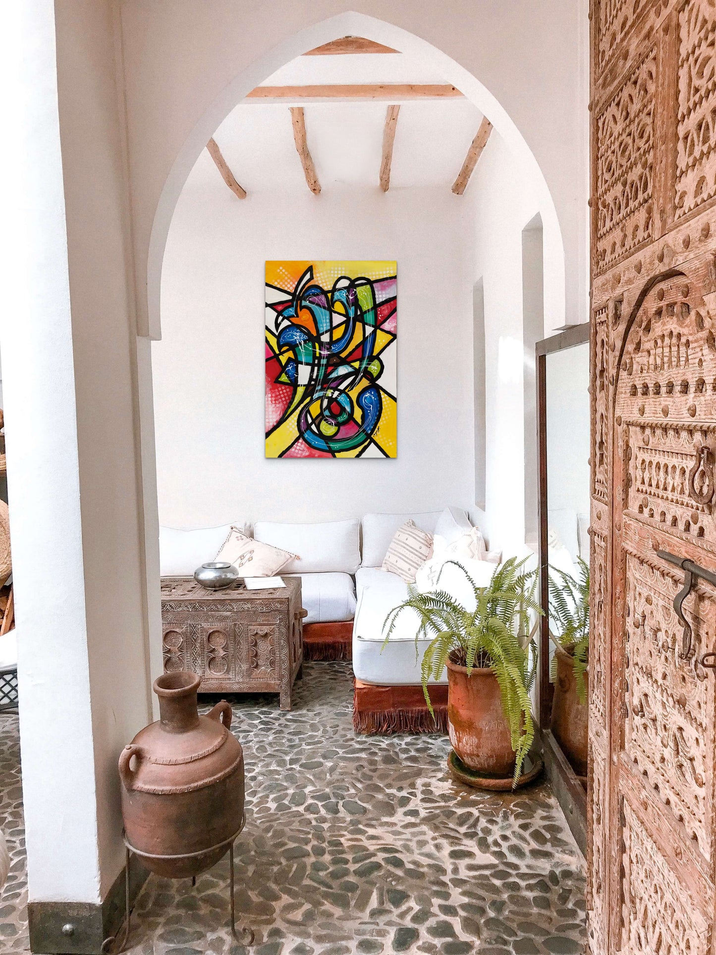 Al Rahman Calligraphy painting in a Mediterranean home. It brings color and sophistication that is sure to spur up conversation 